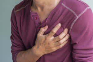 A man clutches his chest